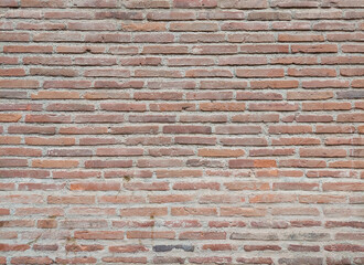 The texture of an old red brick wall