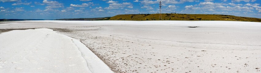Fototapeta na wymiar Salt desert - drying Kuyalnitsky estuary. White table salt at the bottom of a dried-up reservoir, Ukraine