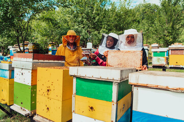 Arab investors checking the quality of honey on a large bee farm in which they have invested their money. The concept of investing in small businesses