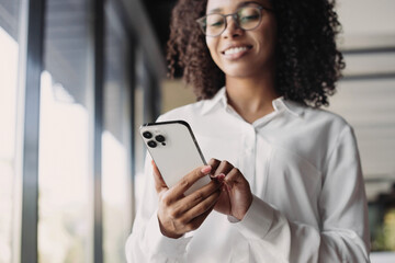 Business woman using smartphone in modern office, Student girl texting on mobile phone indoors,...