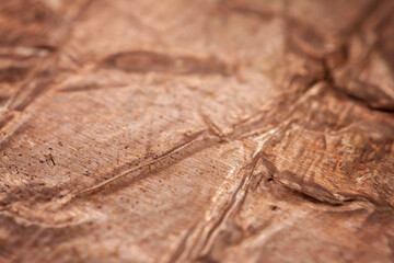 Extreme closeup of crumpled brass foil texture
