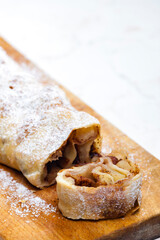 apple strudel on wooden board