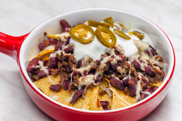 nachos baked with mince beef meat, cheese and red beans