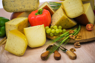Bosnian traditional cheese served on a wooden container with peppers, parade and onions isolated on a white background