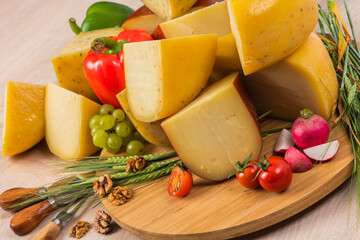 Bosnian traditional cheese served on a wooden container with peppers, parade and onions isolated on...
