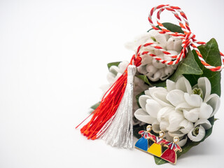 Fototapeta premium bouquet of snowdrops and red white strings and tricolor brooch on white background, 1st of March holiday, Martisor