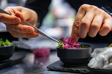 Chef cooking vegetables salad on restaurant kitchen