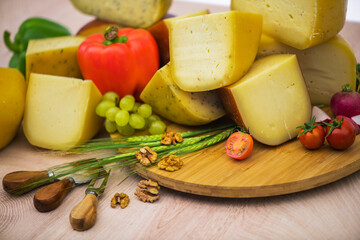 Bosnian traditional cheese served on a wooden container with peppers, parade and onions isolated on a white background