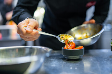 Chef cooking vegetables salad on restaurant kitchen