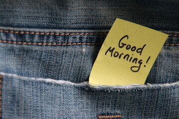 Good morning inscription on a tag in a pocket of blue jeans.