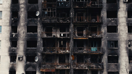 A burnt-out high-rise in the war zone. Damage to a residential building as a result of artillery...
