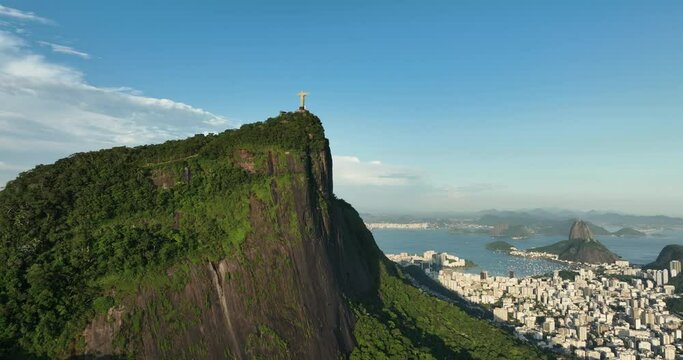 Aerial low angle pan view of Corcovado Hill with Christ on the top and Sugarloaf Mountain behind Botafogo Bay Rio de Janeiro, Brazil
