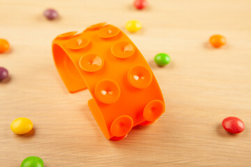 image of antistress silicon toy candies wooden desk background
