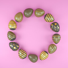 3d render of 13 black and gold easter eggs on pink background.