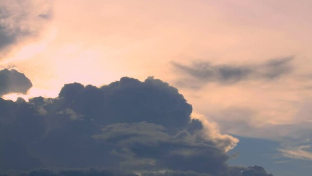 Spectrum sunbeam shining through fluffy puffy cloud.
