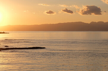 Fototapeta na wymiar The setting sun coloring the sky over Enoshima, Japan