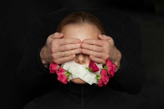 Domestic violence and harassment concept. Woman with closed mouth and male hands on her eyes
