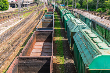 Railway transport. Railway wagons at the station for the transportation of goods. Rails at the railway station. Empty open freight cars on the railway.