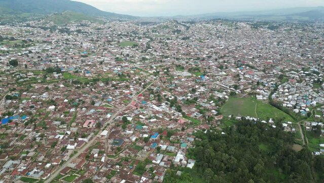Aerial view of Mbeya city in Tanzania, Africa. Town is located in south west of Tanzania. Narrow highland valley surrounded by a bowl of high mountains.