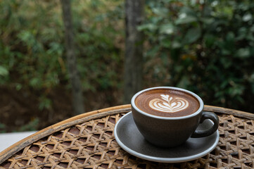 Latte art coffee on a wooden table near the forest coffee on a wooden table near the forest
