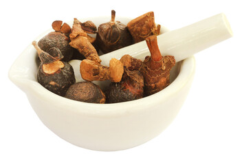 Soapnuts and sweet flag in a mortar with pestle