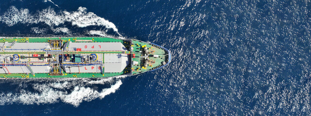 Aerial drone ultra wide top view photo of industrial liquified LPG gas tanker cruising near gas...