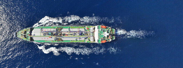 Aerial drone ultra wide top view photo of industrial liquified LPG gas tanker cruising near gas...