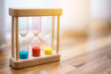 Colorful hourglasses with blurred background cute concept