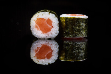 sushi maki roll wrapped in nori seaweed with salmon 