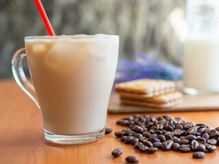 a glass of milk next to a pile of coffee beans, glass of milk on background
