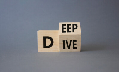 Deep Dive symbol. Concept words deep dive on wooden cubes. Beautiful grey background. Business and...