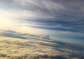 Sunrise above clouds from airplane window