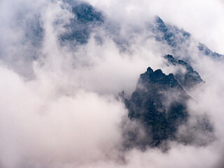 Fototapeta na wymiar Sharp peaks of the Polish Tatra Mountains in clouds and fog