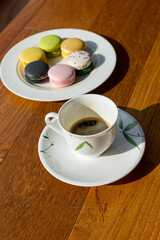 Cup of coffee and french macaron on an old wooden table. , top view