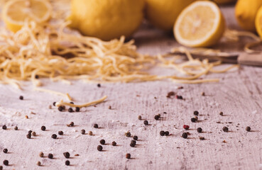 Black Pepper on a kitchen table with pasta and lemons in the background