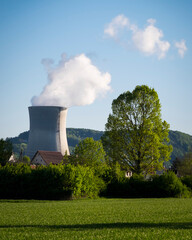 Nuclear power plant in Leibstadt, Aargau Switzerland, generates steam clouds while surrounded by...
