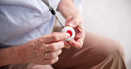 Senior Woman Pressing Alarm Button