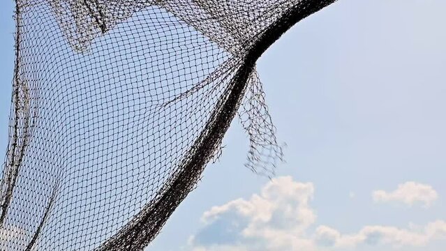 old fishing nets blowing in the wind and blue sky