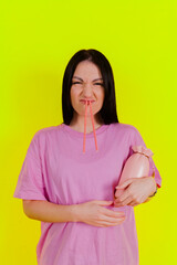 Obraz premium Charming joyful girl posing and express emotions against a bright lime green background. People emotions, Fun and carefree self-expression.