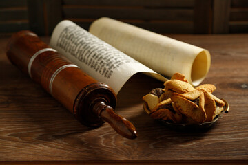 The Scroll of Esther and Purim Festival objects on a dark wooden table. Rustic. - obrazy, fototapety, plakaty