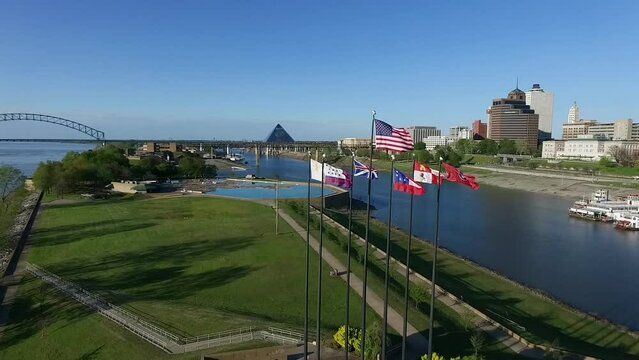 Waving Flags in Mud Island River Park Seven Flagpoles, Memphis, Tennessee. Hernando de Soto Bridge and Mississippi River in Background