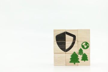 shield front of tree and earth globe icons on wooden block cubes on white background