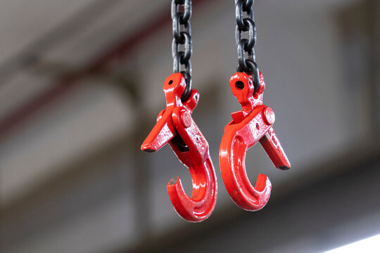 Industrial chains and hooks with shabby red paint