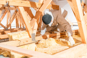 work on the attic of the house, insulated with glass wool