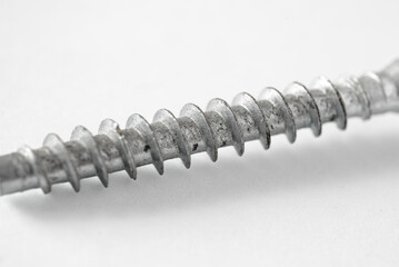 A close up of a screw on white background