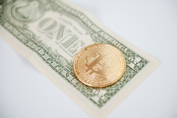 moneta bitcoin na tle jednego dolara