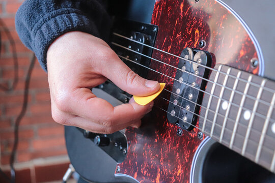 Man Playing Electric Guitar At Home