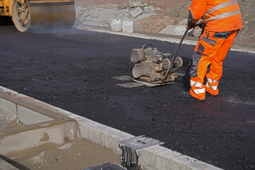 Asphalting of a new road on a construction site housing construc