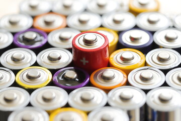 many round batteries and one red battery