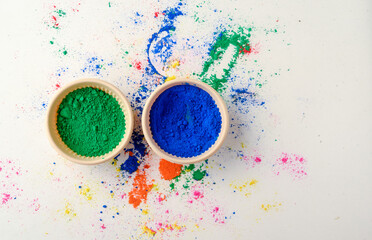 top view of colorful traditional holi powder in bowls isolated on dark background.Space for text ....